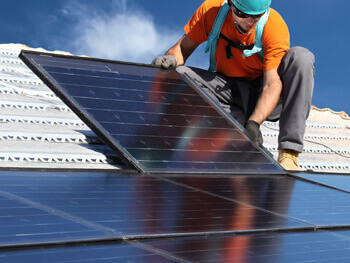 Electrical contractor installing solar panels